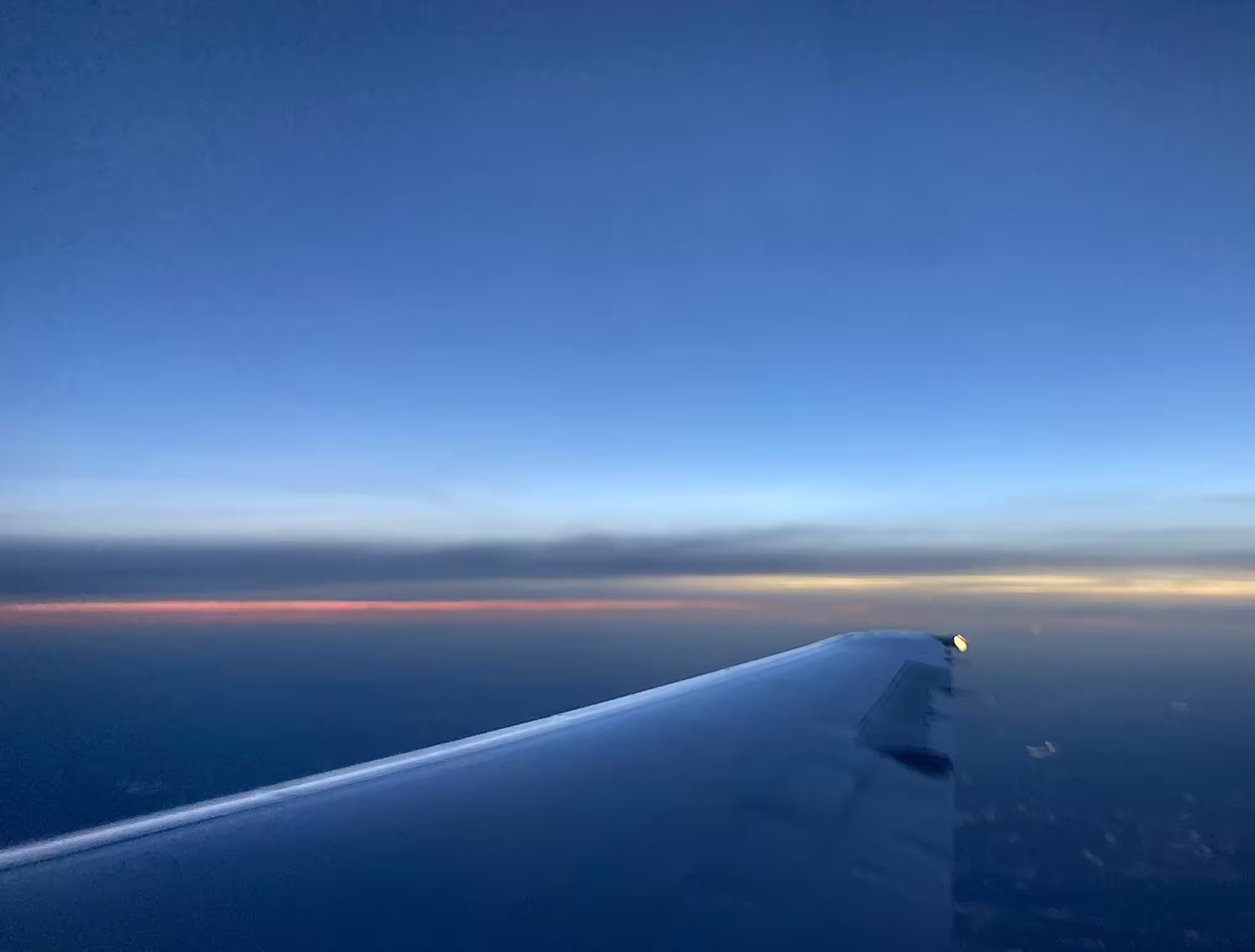 wing of plane at sunset